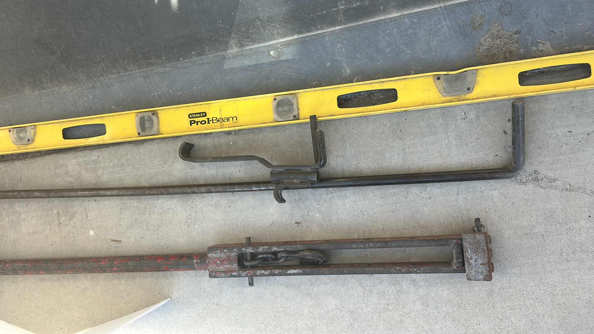 Photo 1 of THREE VERY LARGE METAL TOOLS, PUSH PULL, JACK 56" AND 6’ LEVEL