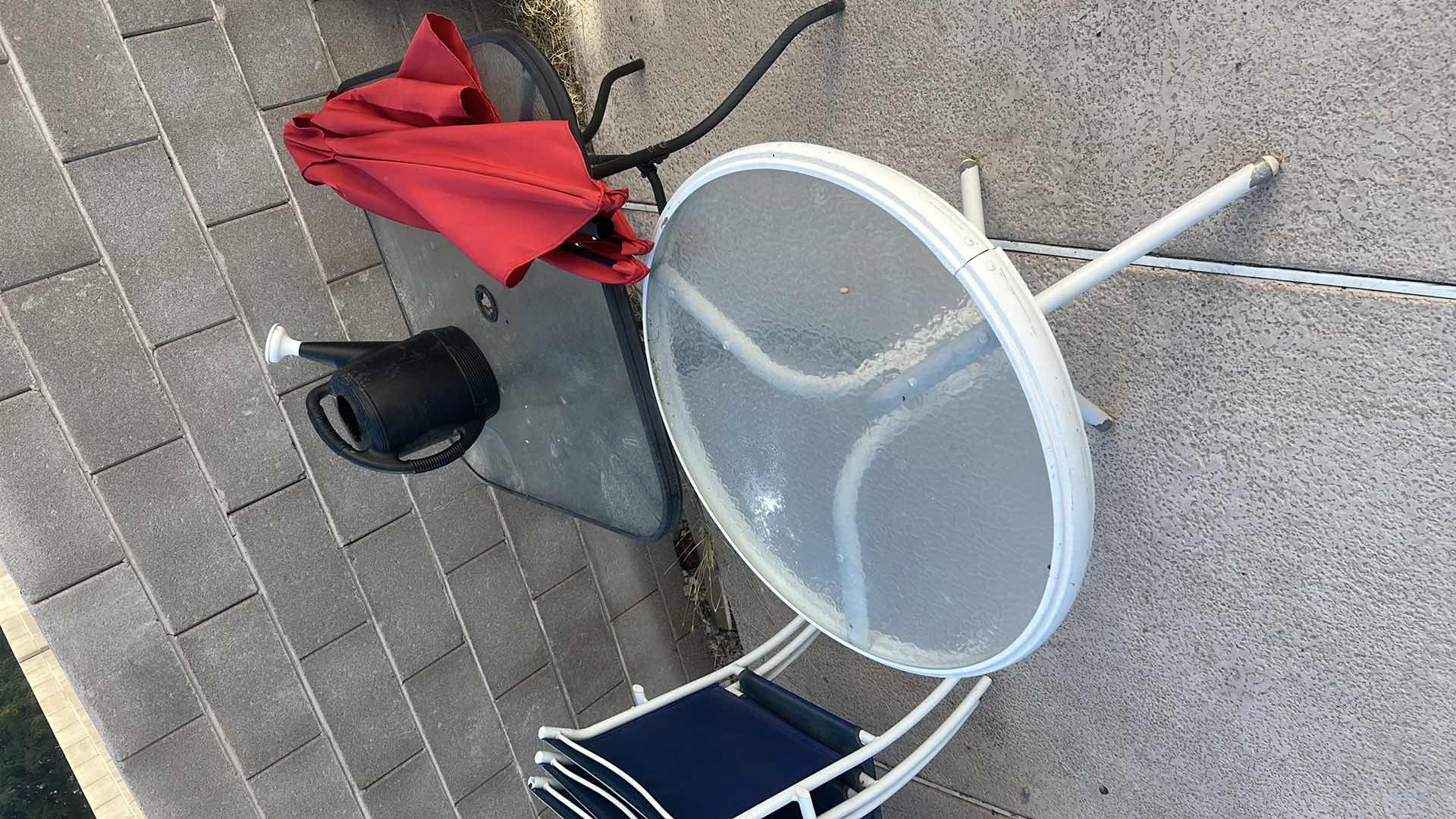 Photo 1 of TWO OUTDOOR TABLES, UMBRELLA (NEEDS LOWER POLE) AND WATERING JUG
