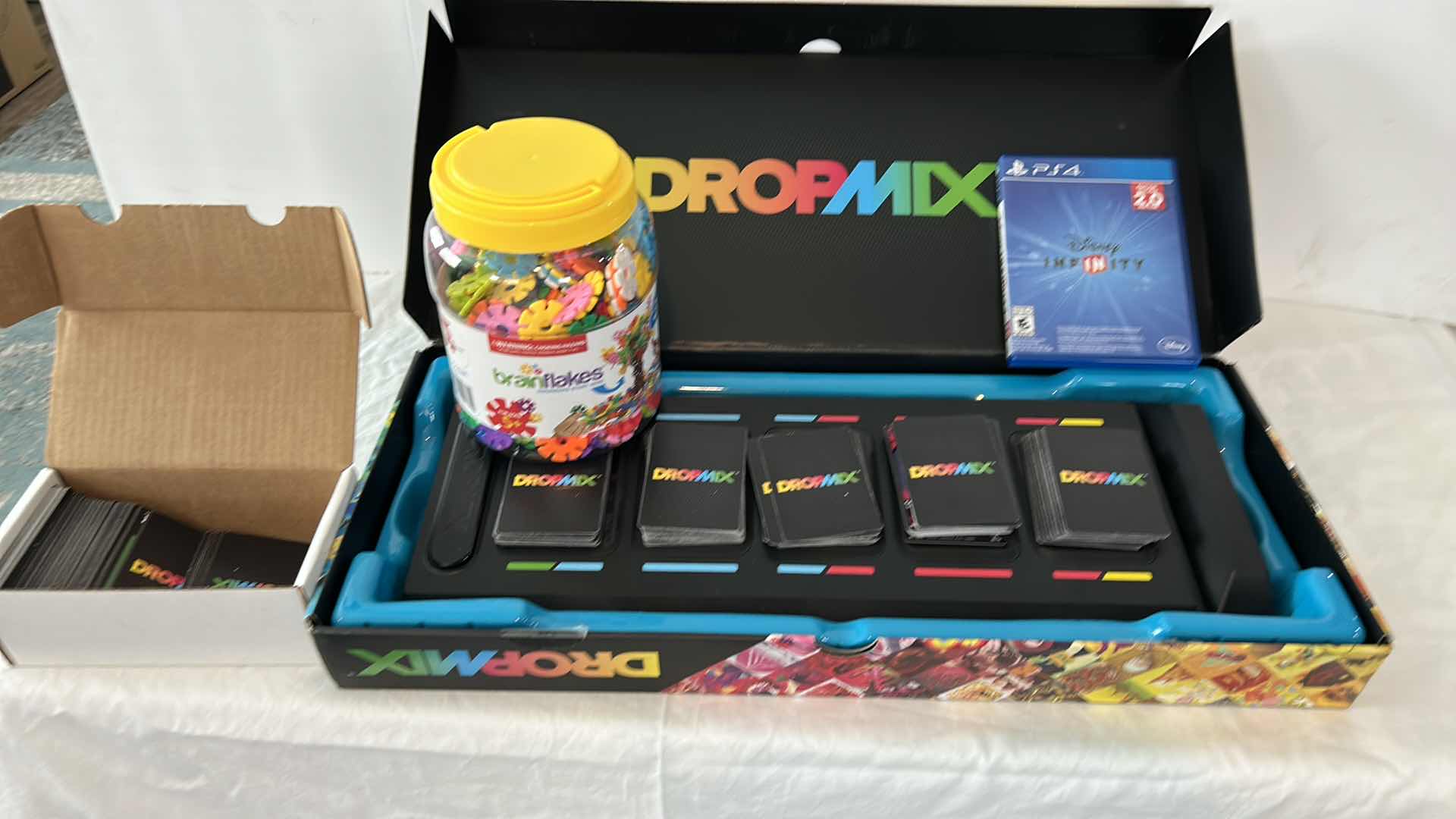Photo 1 of 3 CHILDRENS GAMES-  PS4, DROPMIX MUSIC MIXING GAME AND BRAIN FLAKES