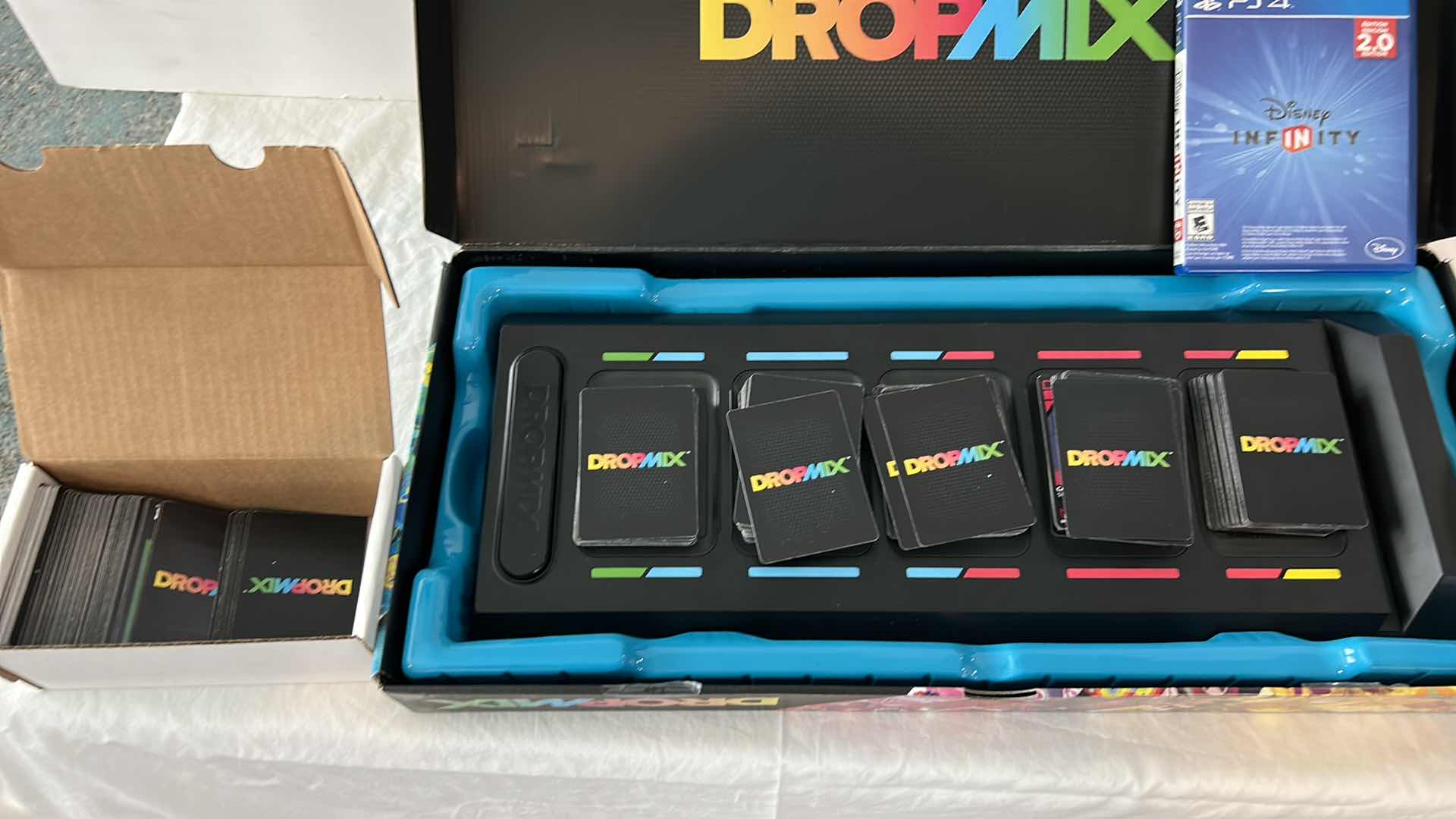 Photo 1 of 3 CHILDRENS GAMES-  PS4, DROPMIX MUSIC MIXING GAME AND BRAIN FLAKES