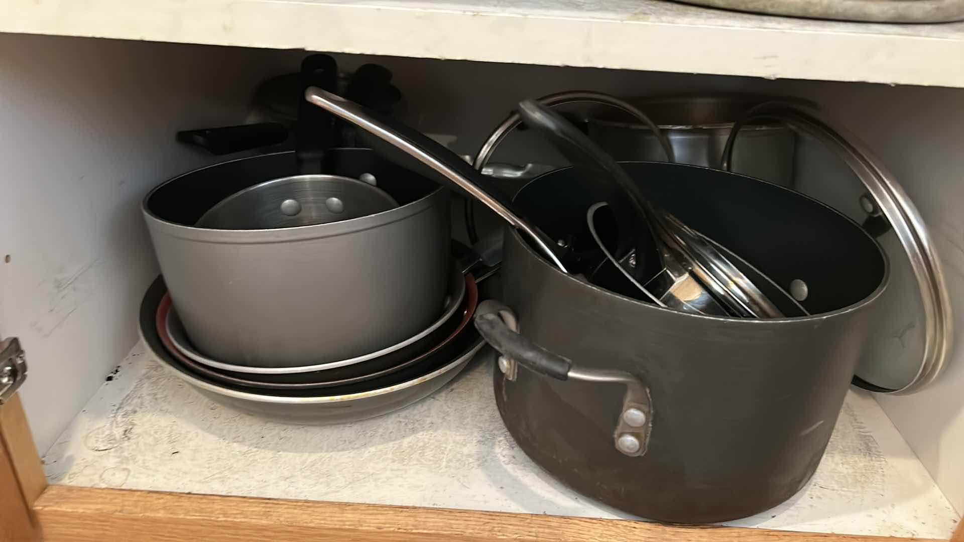 Photo 1 of CONTENTS OF KITCHEN CABINET-.POTS PANS AND MORE