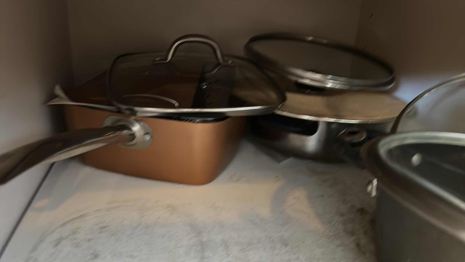 Photo 1 of CONTENTS OF KITCHEN CABINET-.POTS PANS AND MORE
