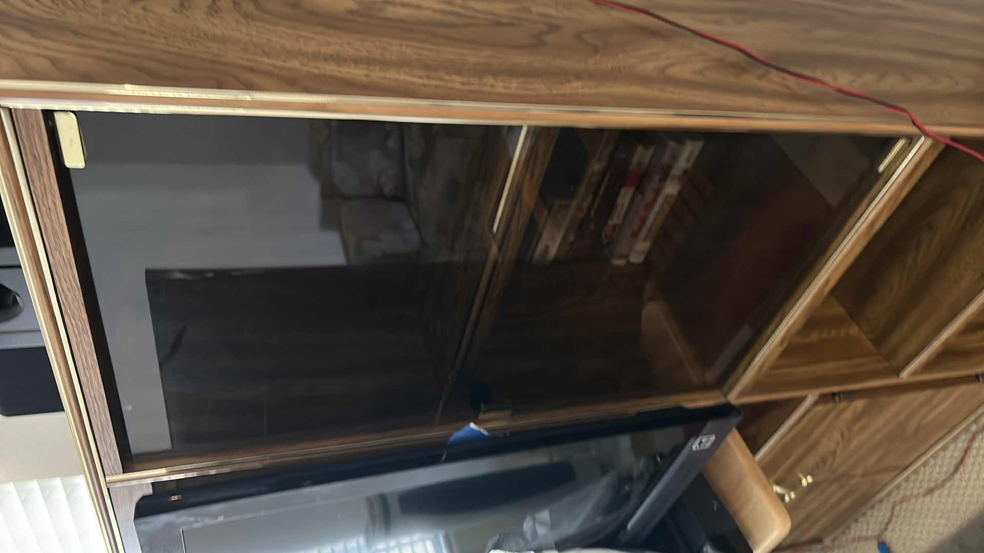 Photo 1 of WOOD ENTERTAINMENT CENTER WITH SMOKED GLASS POP OUT DOORS AND GOLD ACCENT 44“ x 17“ x 57” (CONTENTS SOLD SEPARATELY)