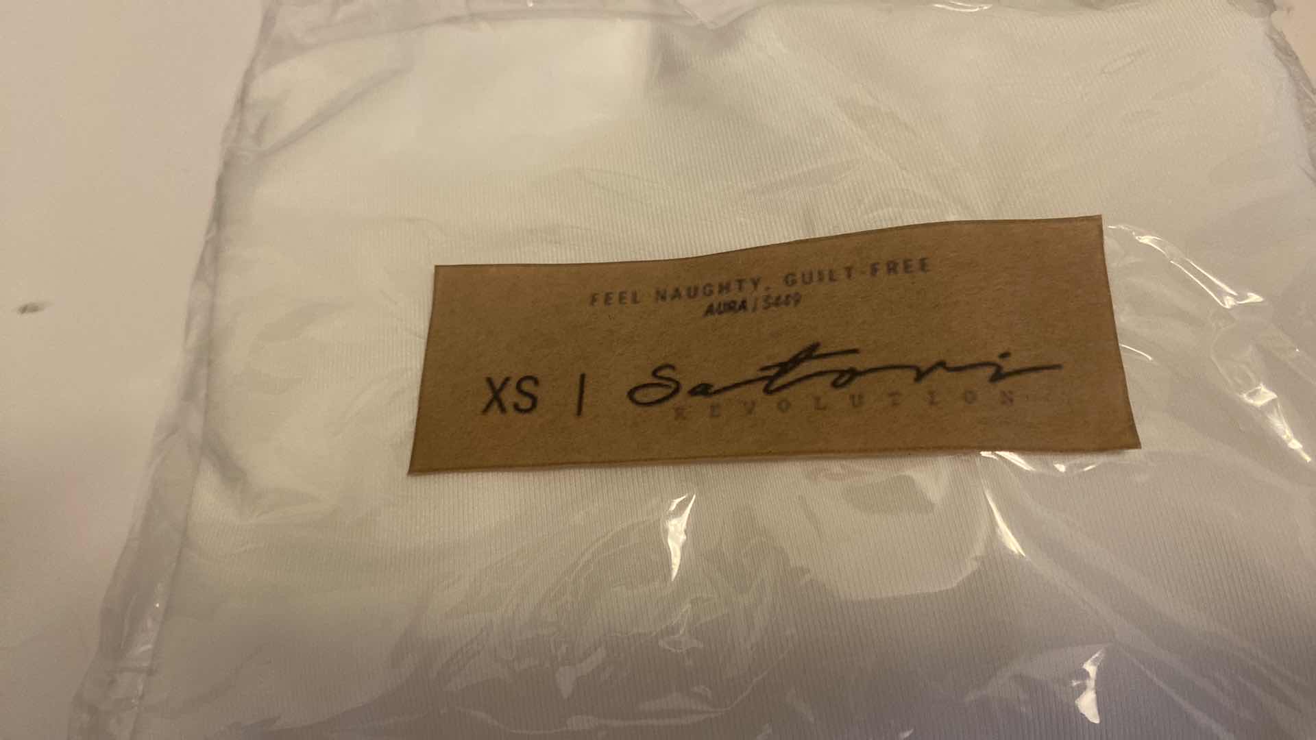 Photo 1 of SIZE X-SMALL WHITE AURA BODYSUIT FEATURES ROUND NECKLINE W EXTENDED STRAPS THAT TIE AND HIGH CUT LEGS, ULTRA SOFT COTTON LINING FOR COMFORT. CAN WEAR AS SWIMWEAR