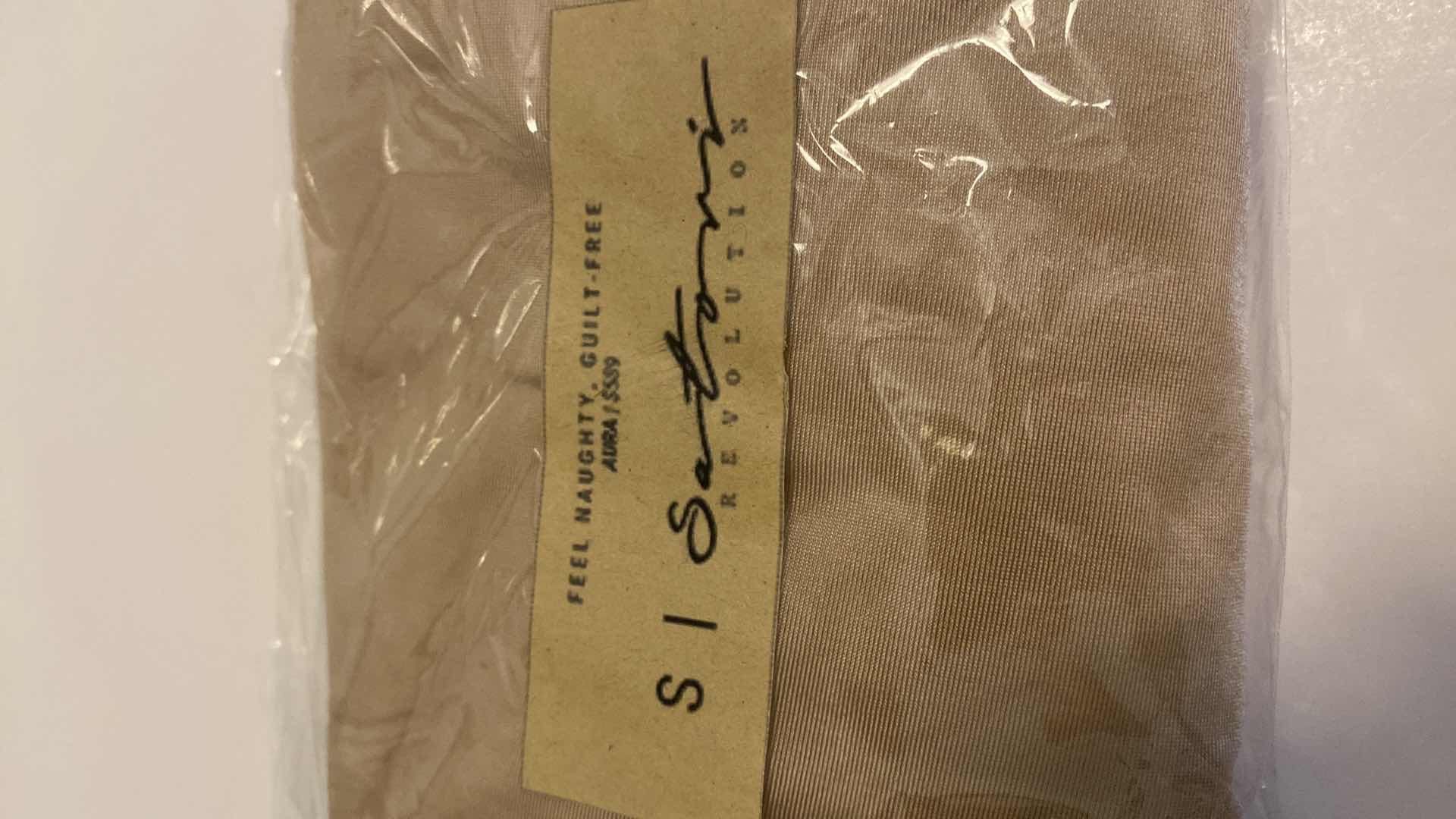 Photo 1 of SIZE SMALL NUDE AURA BODYSUIT FEATURES ROUND NECKLINE W EXTENDED STRAPS THAT TIE AND HIGH CUT LEGS, ULTRA SOFT COTTON LINING FOR COMFORT. CAN WEAR AS SWIMWEAR