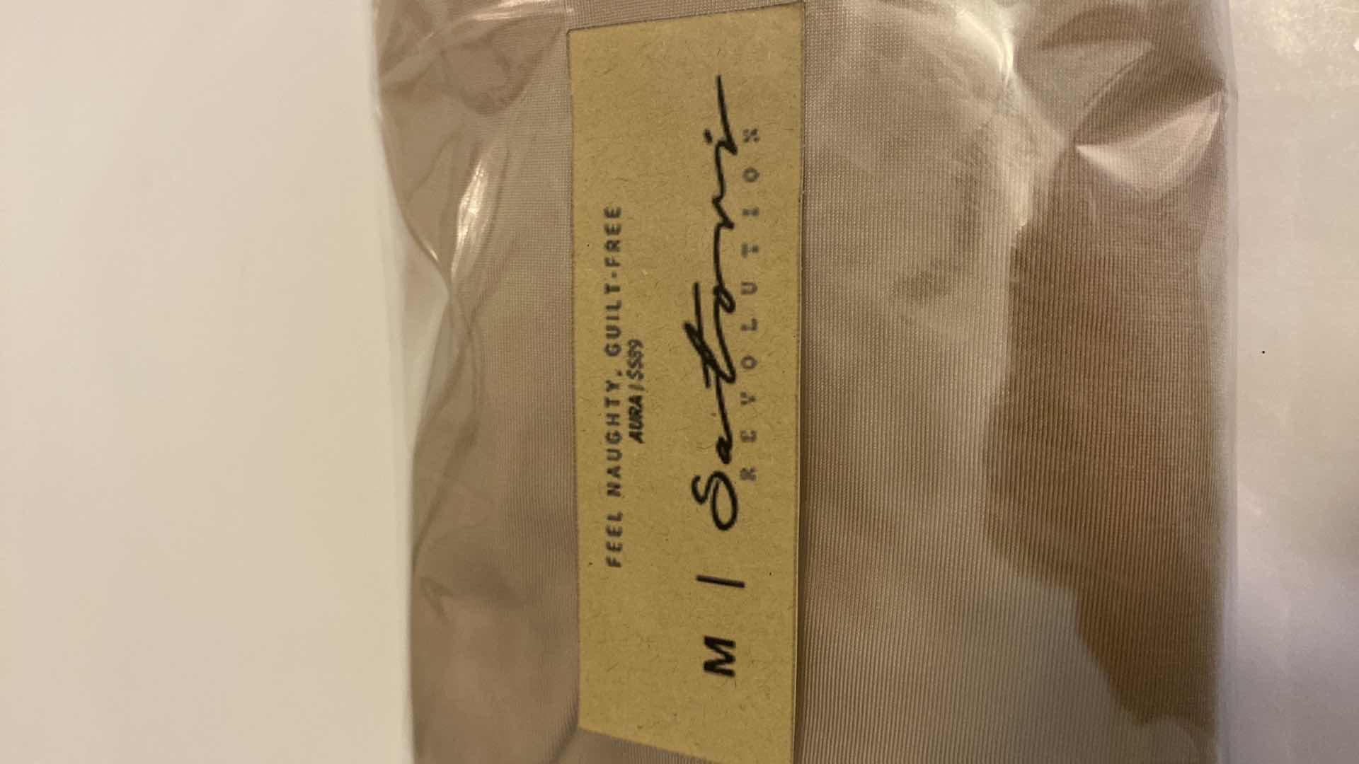 Photo 1 of SIZE MEDIUM NUDE AURA BODYSUIT FEATURES ROUND NECKLINE W EXTENDED STRAPS THAT TIE AND HIGH CUT LEGS, ULTRA SOFT COTTON LINING FOR COMFORT. CAN WEAR AS SWIMWEAR