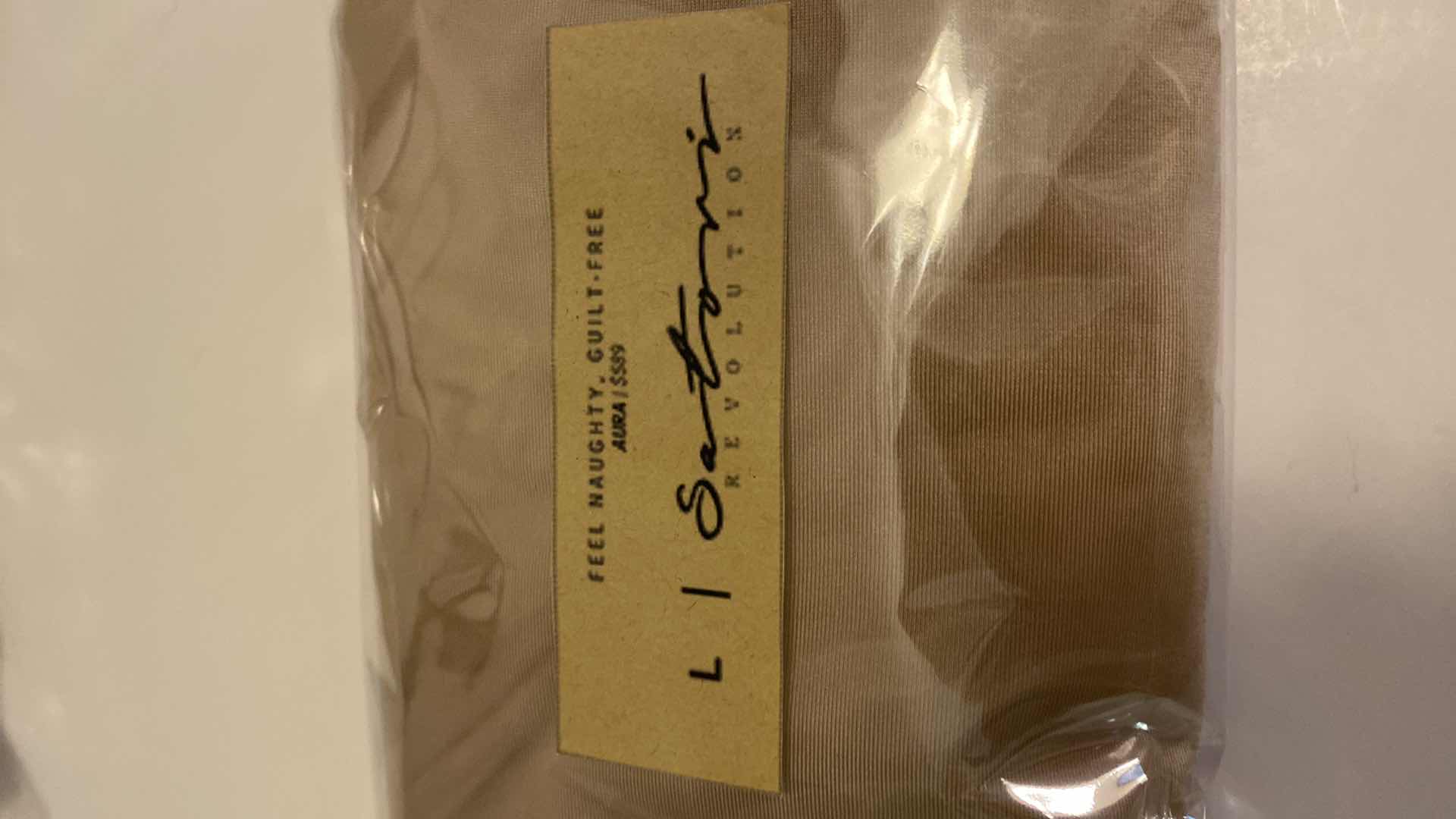 Photo 1 of SIZE LARGE  NUDE AURA BODYSUIT FEATURES ROUND NECKLINE W EXTENDED STRAPS THAT TIE AND HIGH CUT LEGS, ULTRA SOFT COTTON LINING FOR COMFORT. CAN WEAR AS SWIMWEAR