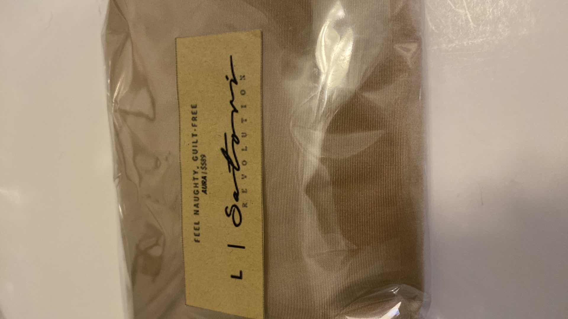 Photo 1 of SIZE LARGE  NUDE AURA BODYSUIT FEATURES ROUND NECKLINE W EXTENDED STRAPS THAT TIE AND HIGH CUT LEGS, ULTRA SOFT COTTON LINING FOR COMFORT. CAN WEAR AS SWIMWEAR