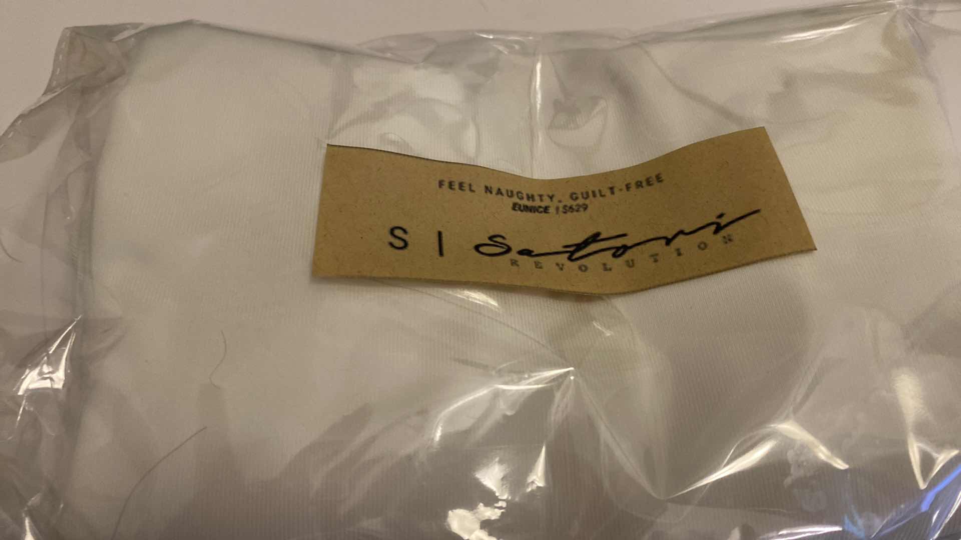 Photo 1 of SIZE SMALL WHITE EUNICE BODYSUIT FEATURES A BOAT NECK LINE WITH HIGH COURT LEGS AND A LOW CUT ON SIDES THAT GIVE YOU AM EDGY LOOK.