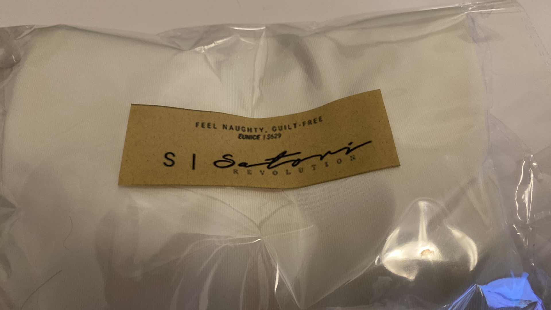 Photo 1 of SIZE SMALL WHITE EUNICE BODYSUIT FEATURES A BOAT NECK LINE WITH HIGH COURT LEGS AND A LOW CUT ON SIDES THAT GIVE YOU AM EDGY LOOK.