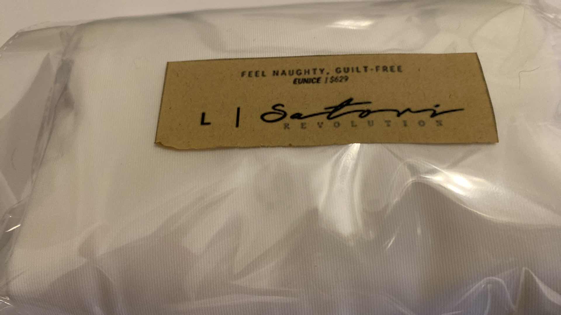 Photo 1 of SIZE LARGE WHITE EUNICE BODYSUIT FEATURES A BOAT NECK LINE WITH HIGH COURT LEGS AND A LOW CUT ON SIDES THAT GIVE YOU AM EDGY LOOK.