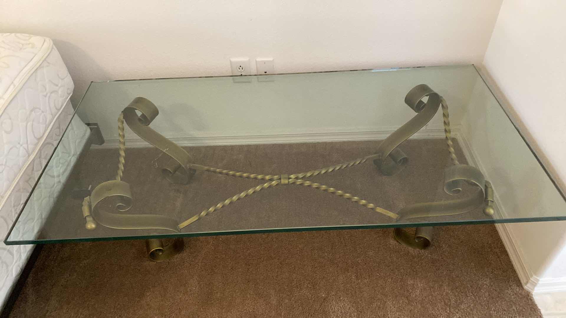 Photo 1 of ANTIQUE BRASS IRON AND 1/2” GLASS COCKTAIL TABLE 60” x 29 1/2”