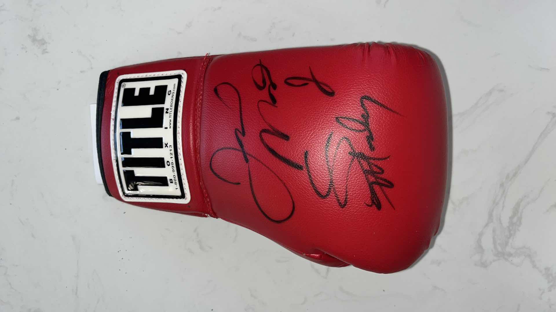 Photo 1 of RED TITLE BOXING GLOVE SIGNED BY “SUGAR” SHANE MOSLEY AND FLOYD MAYWEATHER Jr.