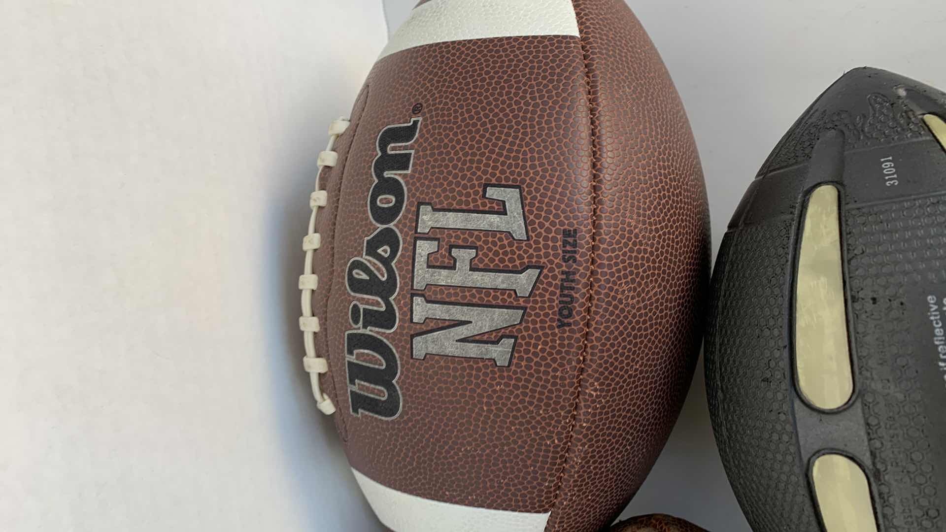 Photo 1 of WILSON NFL FOOTBALLS AND NERF FOOTBALL