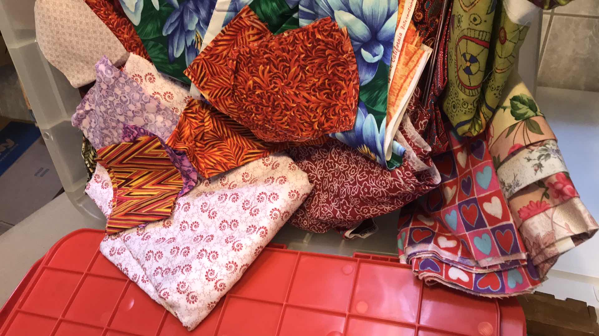 Photo 1 of LARGE BIN OF ASSORTED FABRIC REMNANTS FOR QUILTING