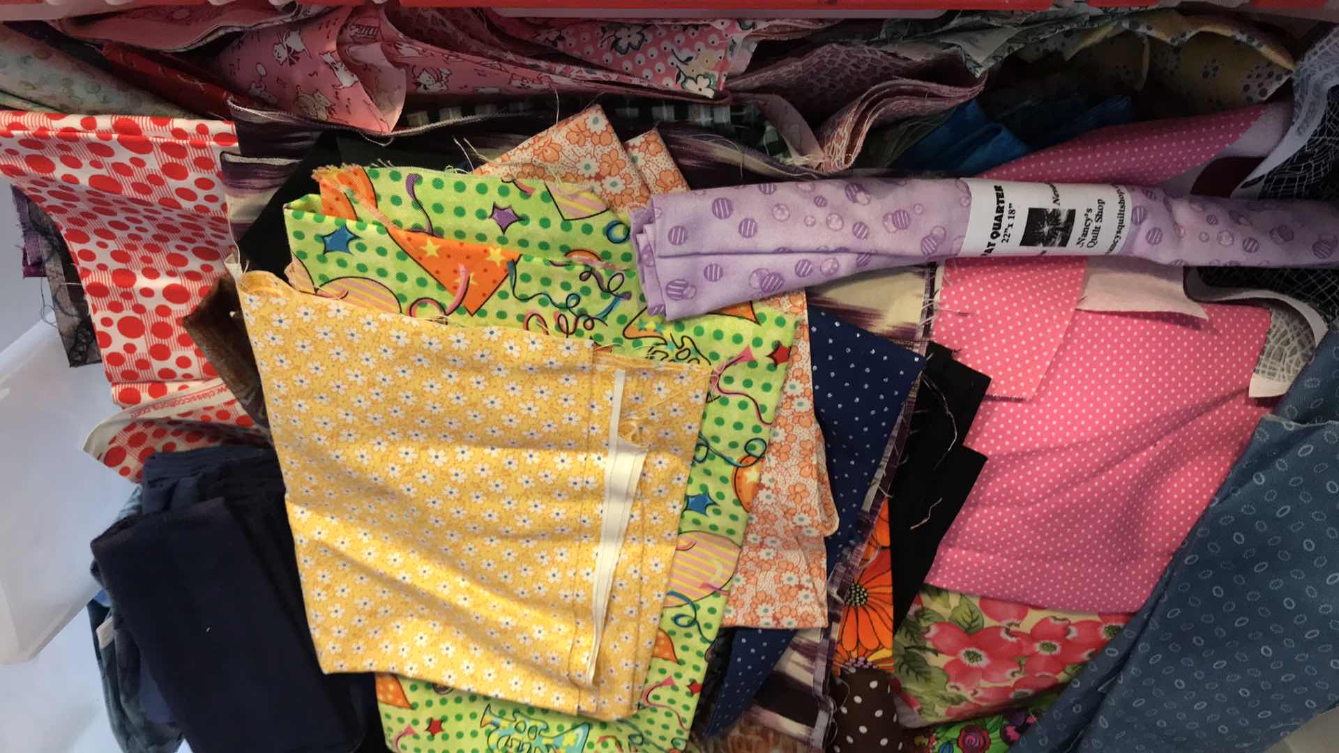 Photo 1 of LARGE BIN OF FABRIC REMNANTS FOR QUILTING