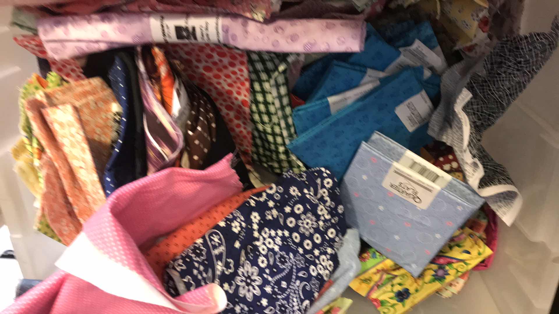 Photo 1 of LARGE BIN OF FABRIC REMNANTS FOR QUILTING
