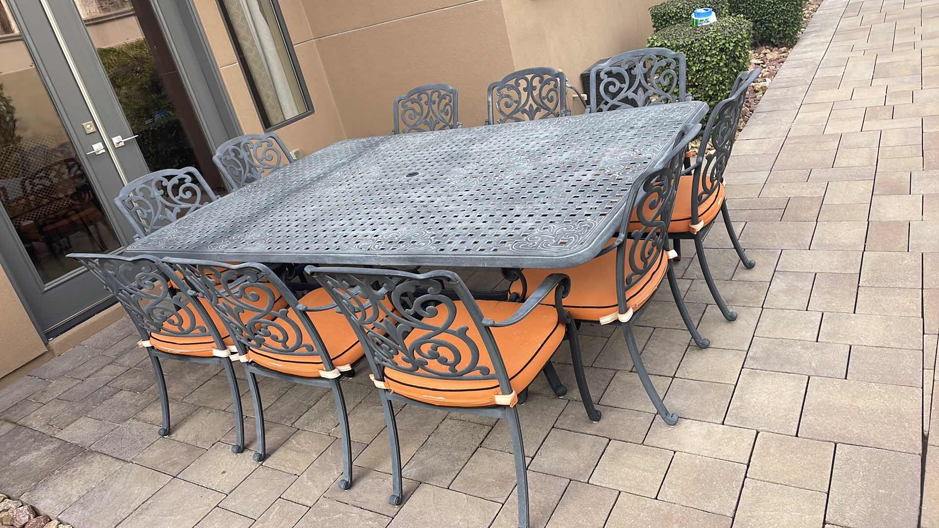 Photo 1 of LUXURY PATIO FURNITURE SET - TABLE 64” X 90” WITH 10 CHAIRS ORANGE CUSHIONS WITH BLACK WELTING