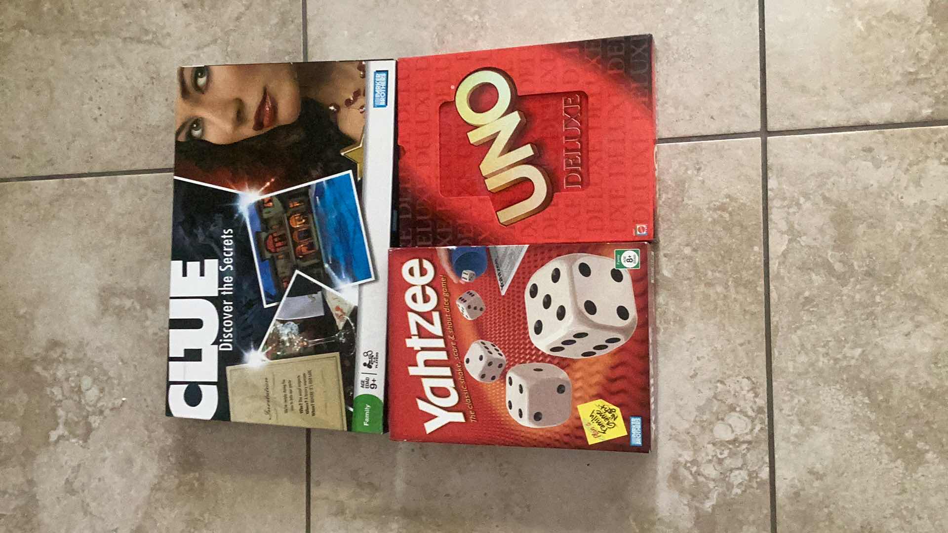 Photo 1 of CLUE, YAHTZEE, AND UNO GAMES