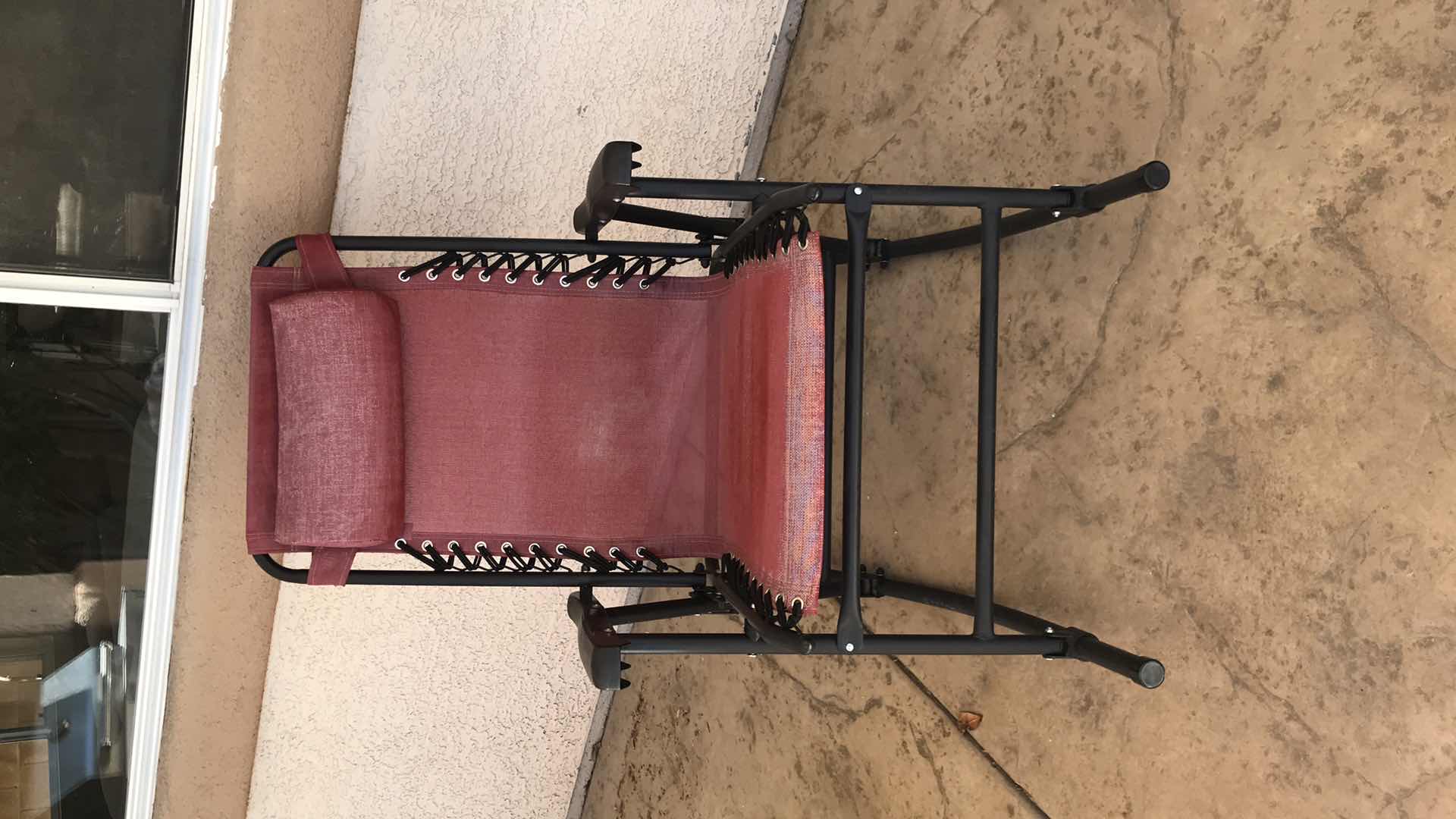 Photo 1 of AMAZON BASICS OUTDOOR TEXTILENE ZERO GRAVITY FOLDING LOUNGE ROCKER WITH PILLOW, RED - SOME SUN DAMAGE 

