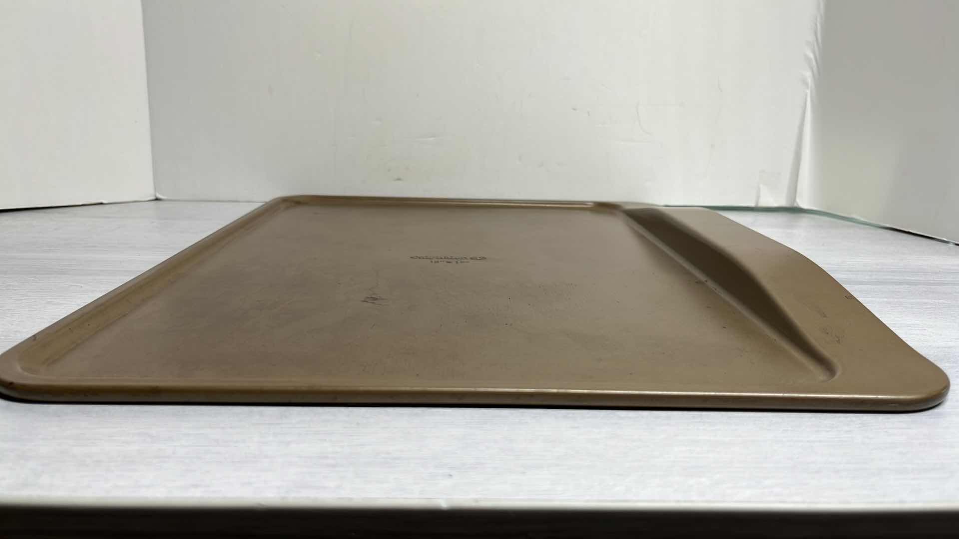 Photo 1 of CALPHALON 12” x 17” BAKING SHEET, 12 CAVITY MUFFIN PAN & 17” ROLLING PIN