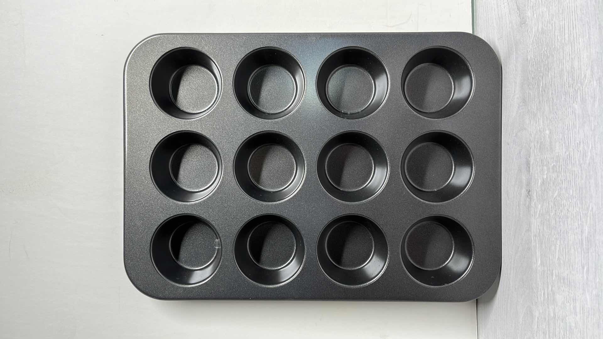 Photo 1 of CALPHALON 12” x 17” BAKING SHEET, 12 CAVITY MUFFIN PAN & 17” ROLLING PIN