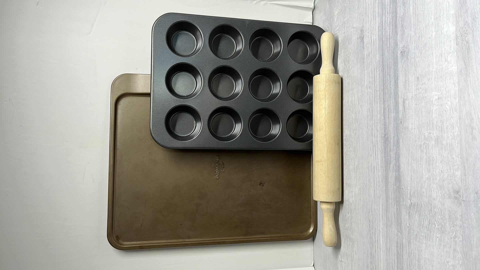 Photo 1 of CALPHALON 12” x 17” BAKING SHEET, 12 CAVITY MUFFIN PAN & 17” ROLLING PIN