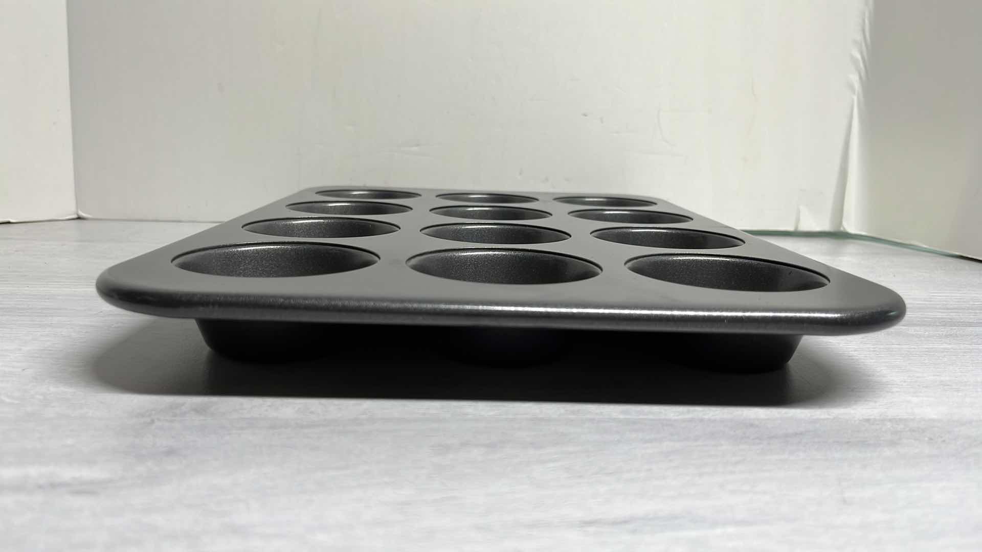 Photo 1 of CALPHALON 12” x 17” BAKING SHEET, 12 CAVITY MUFFIN PAN & 17” ROLLING PIN