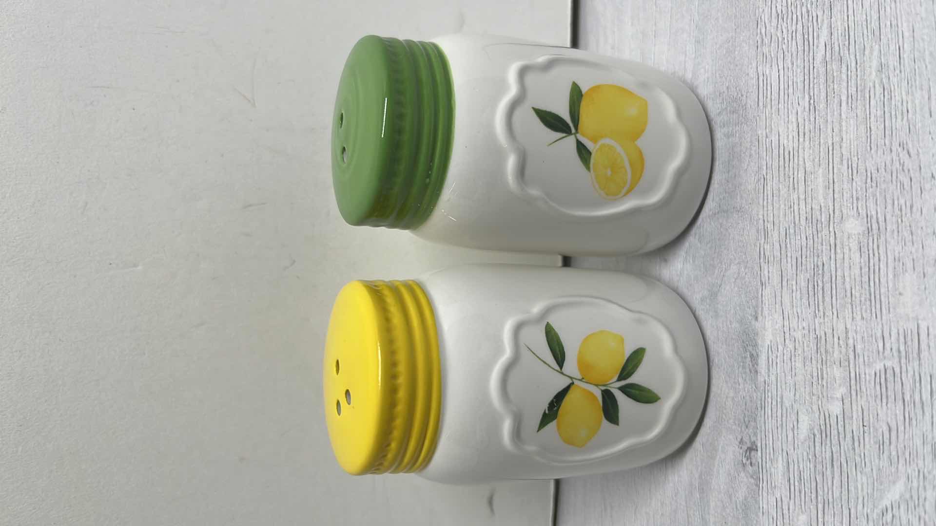 Photo 1 of LEMON DECOR SALT & PEPPER SHAKERS & 2 PACKS OF CASPARI CITRON 3-PLY NAPKINS (15 CT PER PACK)