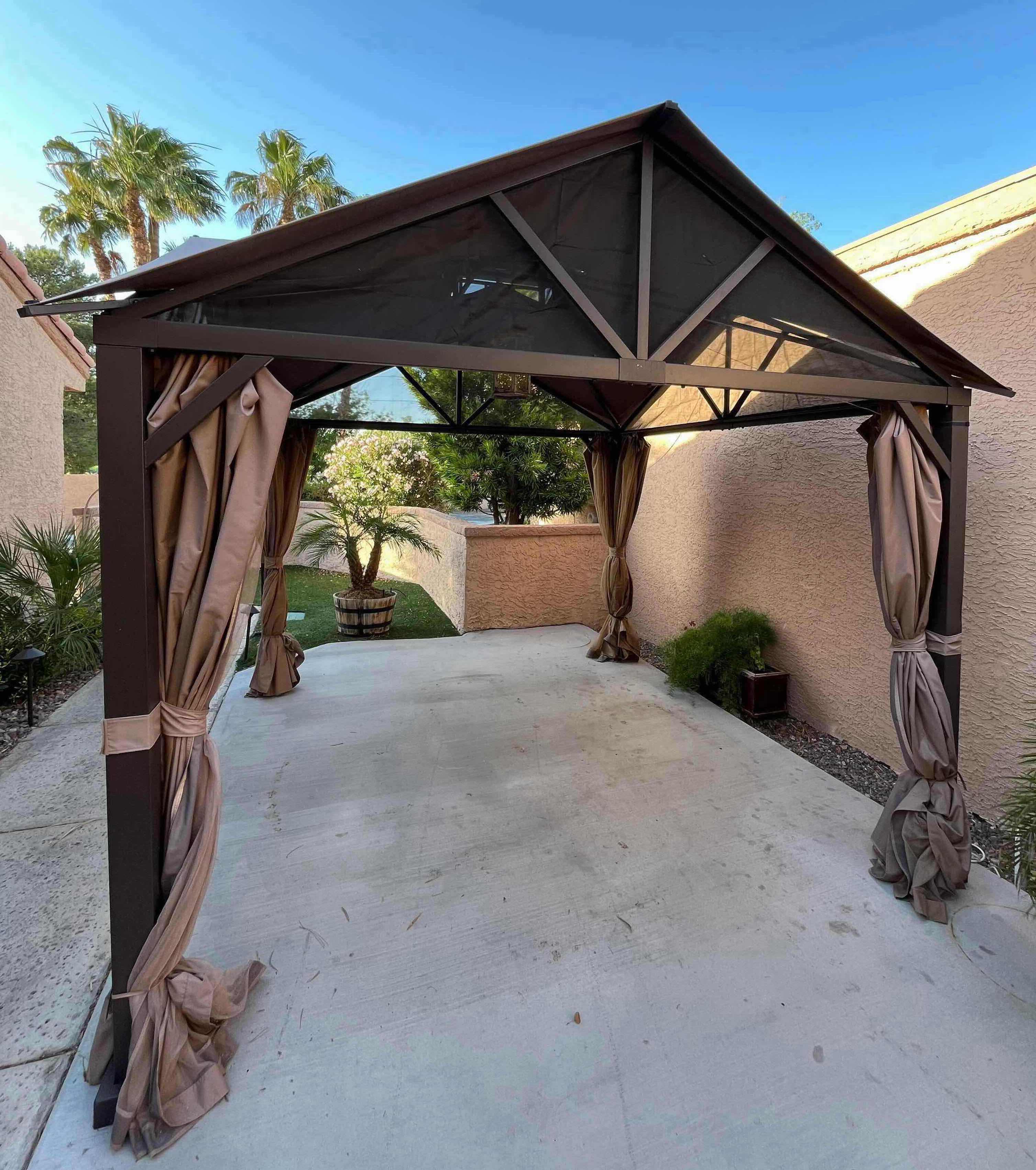 Photo 1 of BLACK STEEL FRAMED GAZEBO PATIO TENT W PRIVACY CURTAINS 124” X 122.5” H132” (READ NOTES)