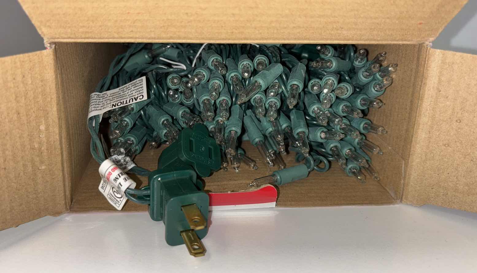 Photo 1 of NEW 2 BOXES CHRISTMAS LIGHT STRANDS- 300 INCANDESCENT CLEAR MINI LIGHTS (68.5’ LIGHTED LENGTH) & 300 MULTI-COLOR MINI LIGHTS (LIGHTED LENGTH 59 FT)