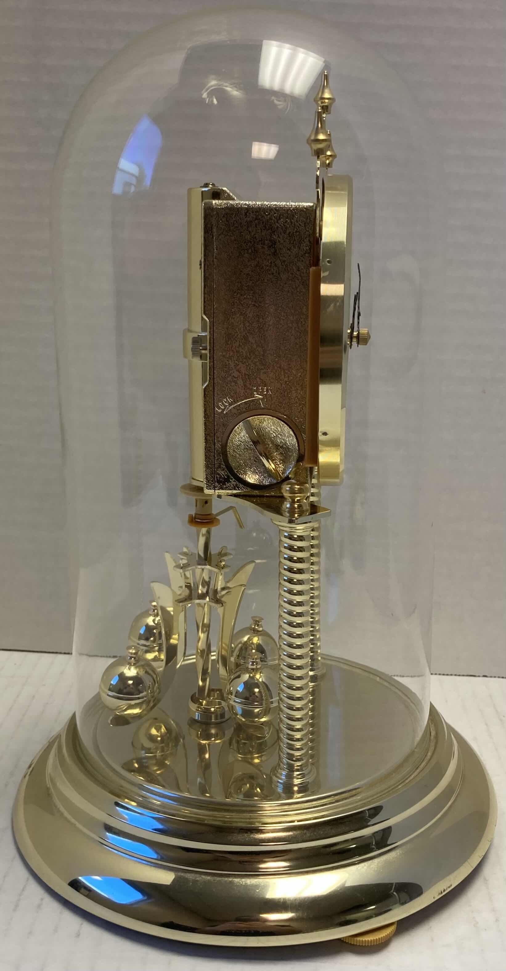 Photo 1 of ELGIN GOLD FINISH ANNIVERSARY JAPANESE BATTERY OPERATED CLOCK W ROTATING PENDULUM 8” X 8” H12”