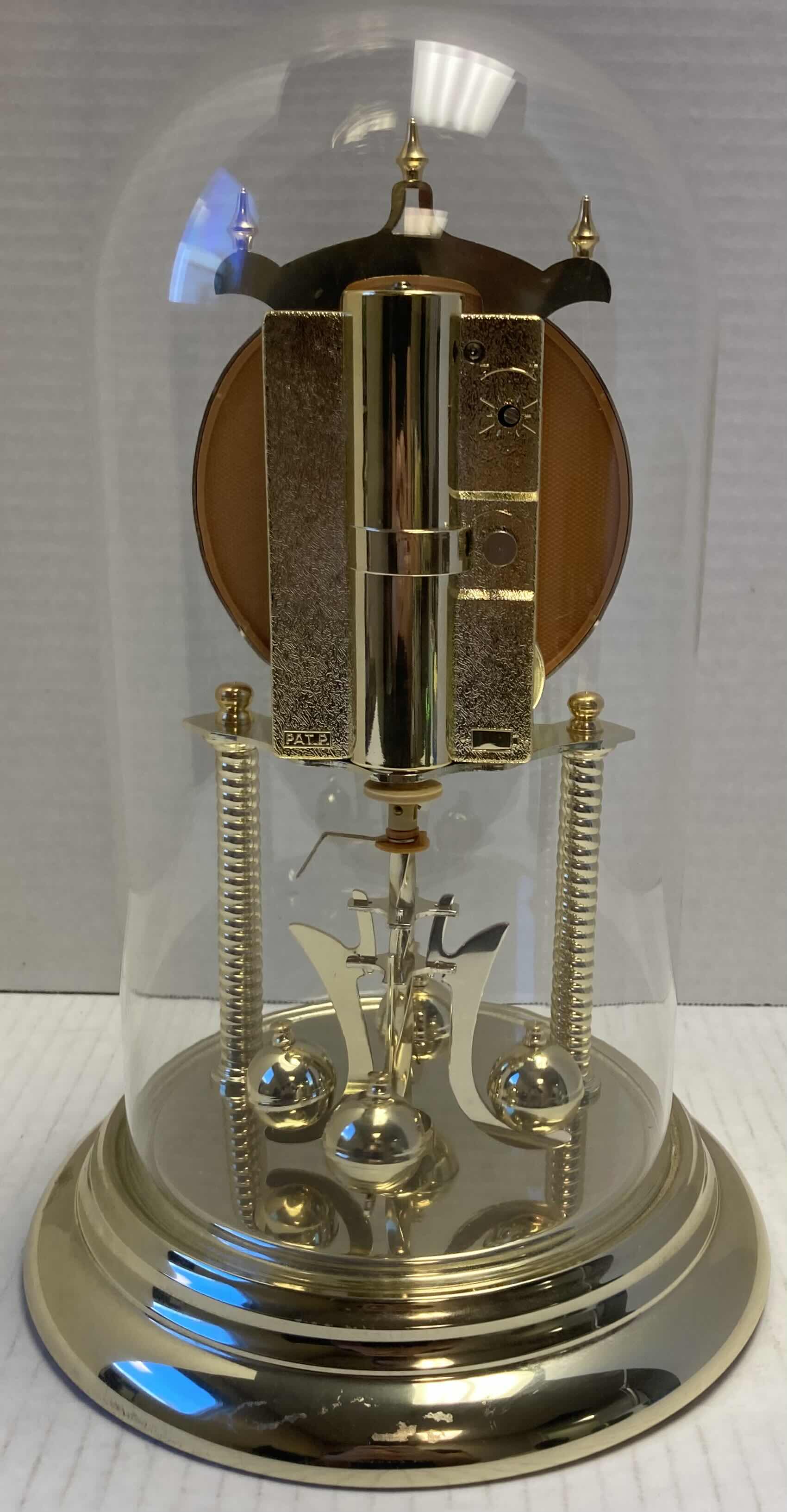 Photo 1 of ELGIN GOLD FINISH ANNIVERSARY JAPANESE BATTERY OPERATED CLOCK W ROTATING PENDULUM 8” X 8” H12”