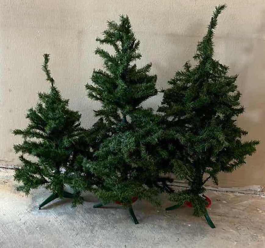 Photo 1 of CHRISTMAS TREES W STANDS (3) 18”-24” X H39”-52”