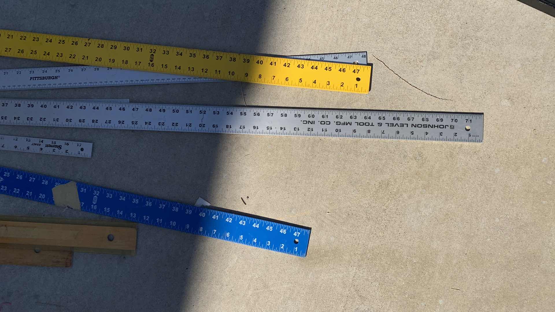 Photo 1 of ASSORTED DRYWALL T SQUARES AND METAL RULERS