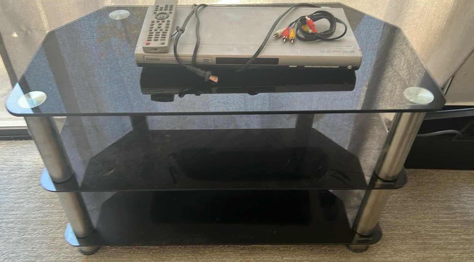 View 1 of SMOKED GLASS ENTERTAINMENT CENTER 32” x 17” H 20” W TOSHIBA DVD PLAYER & REMOTE