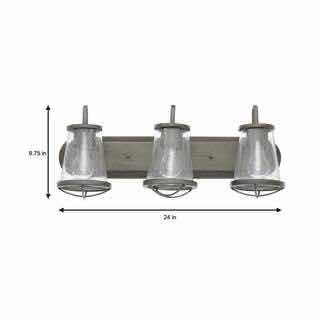 Photo 1 of HOME DECORATORS COLLECTION WEATHERED IRON FINISH & CLEAR SEEDED GLASS SHADES GEORGINA 3-LIGHT VANITY FIXTURE 1004 693 656