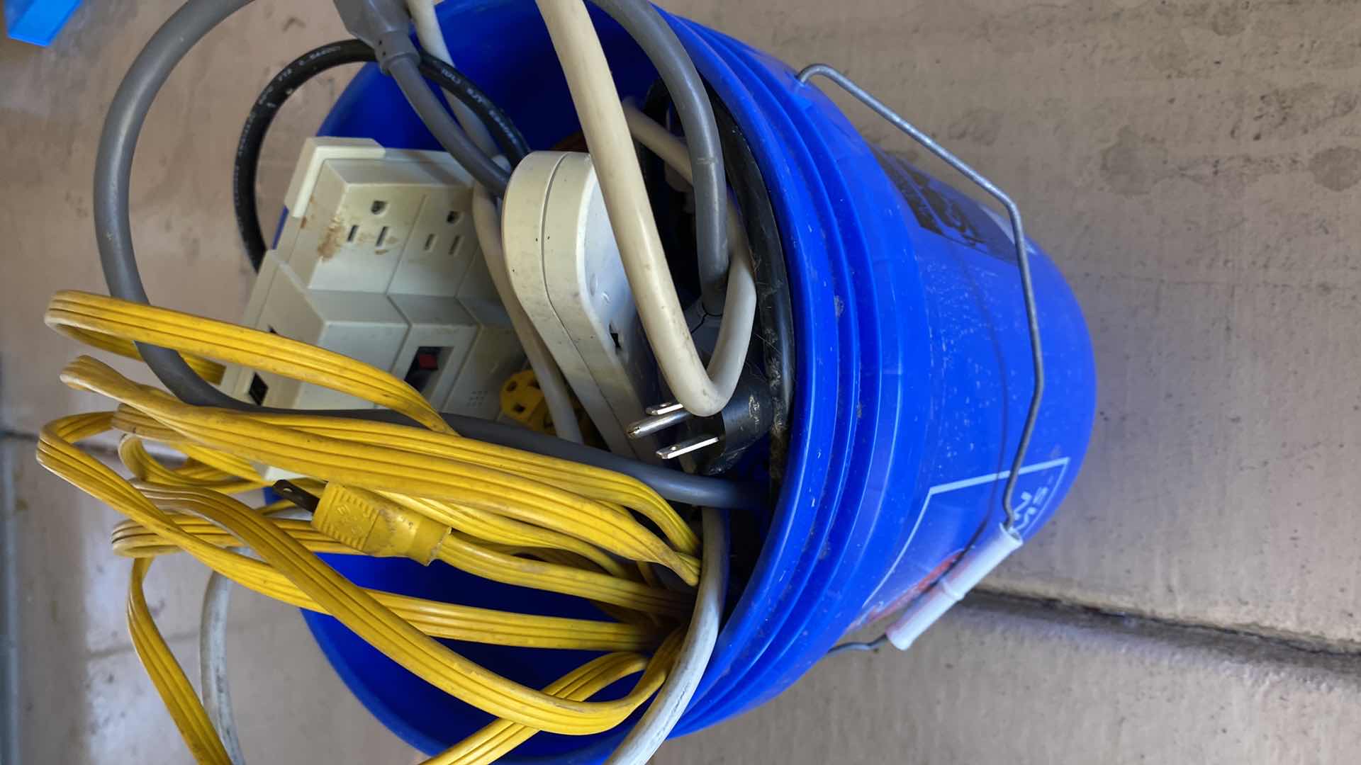 Photo 1 of BUCKET WITH ELECTRICAL CORDS AND SURGE PROTECTORS