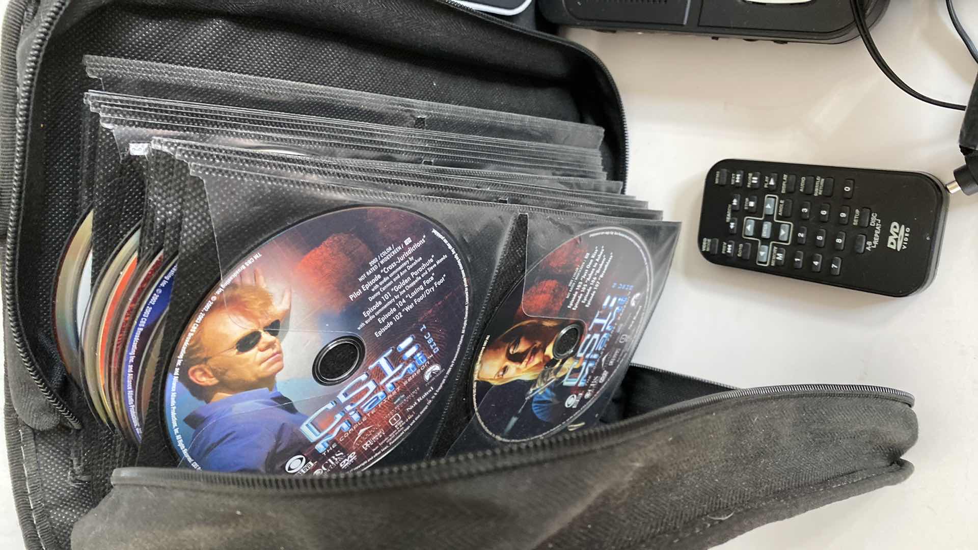 Photo 1 of RCA DVD PLAYER WITH CORDS REMOTE AND CASE WITH CSI MIAMI DVDS