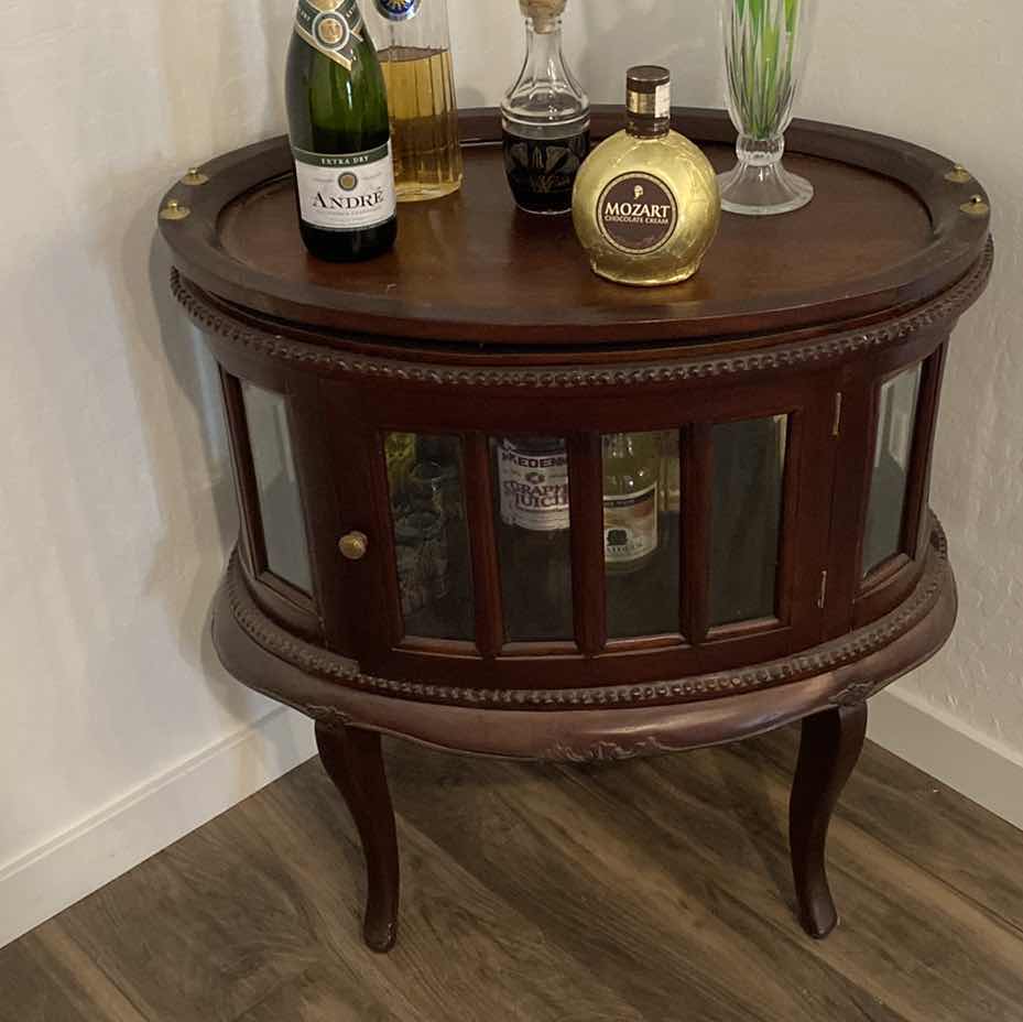 View 1 of OVAL WOOD CABINET WITH BEVELED GLASS 29“ x 19 1/2“ H 31” contents, not included