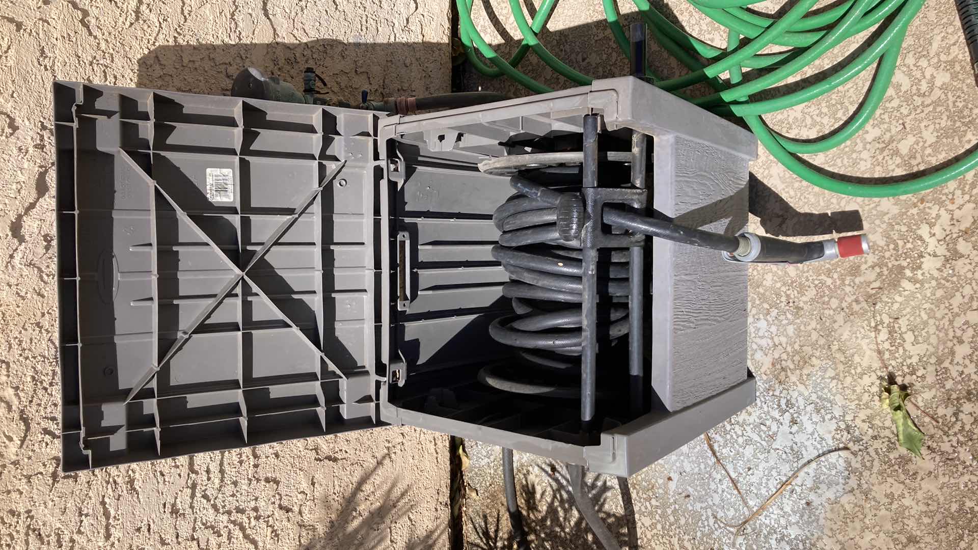 Photo 1 of SUNCAST OUTDOOR HOSE STORAGE W BLACK HOSE (APPROX 50’)& GREEN HOSE (APPROX 50’)