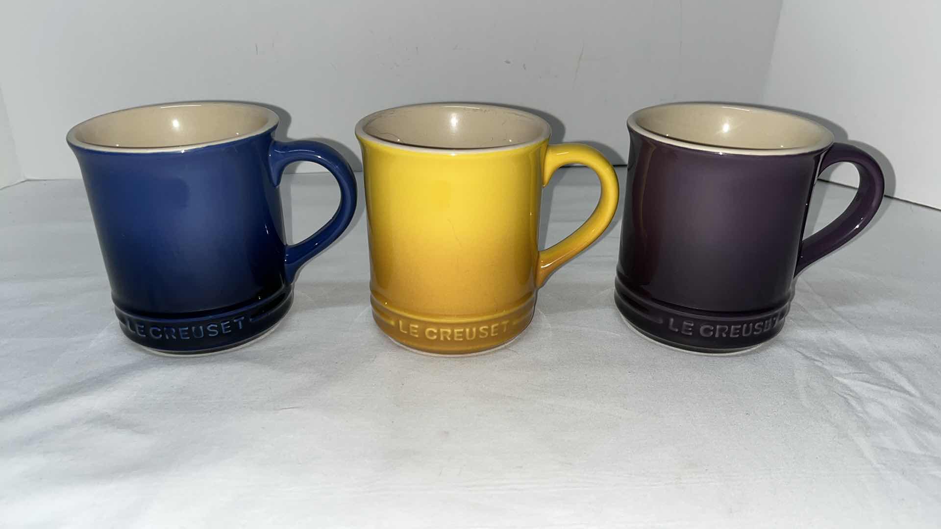 Photo 1 of LE CREUSET STONEWARE SET OF 3, 15 OZ MUGS