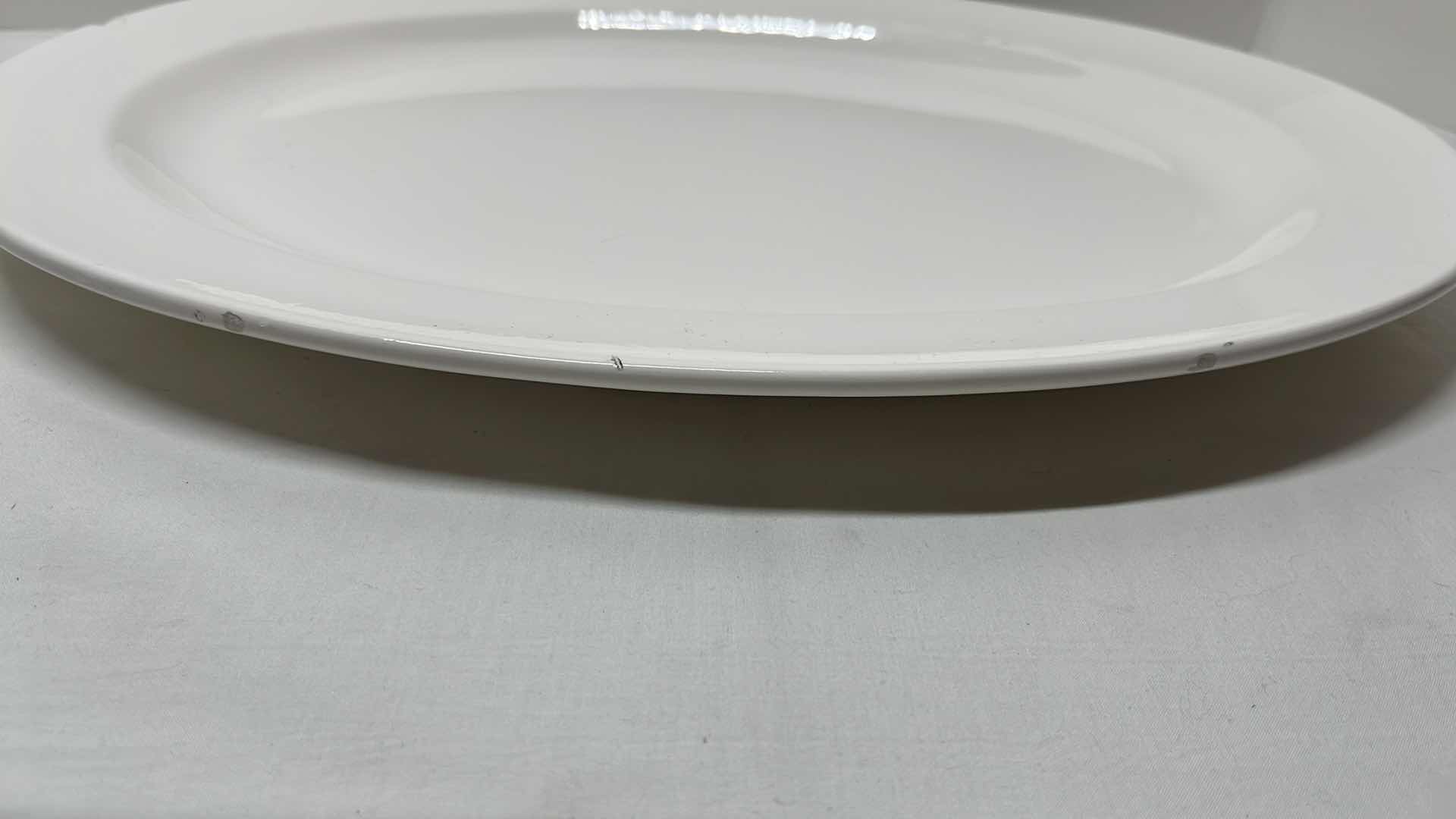Photo 1 of 2 PCS CERAMIC SERVING PLATTERS 
BLACK 13.5” X 13.5”
WHITE 14.25” X 18”