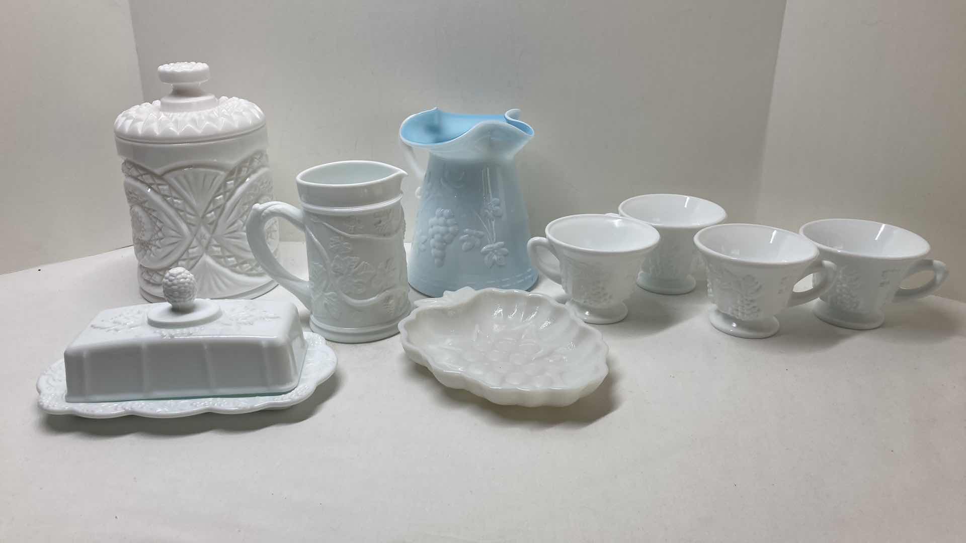 Photo 1 of MILK GLASS GRAPEVINE TEA CUP SET (4) MILK GLASS COOKIE JAR & SERVING DISHES- VARIOUS DESIGNS (4)