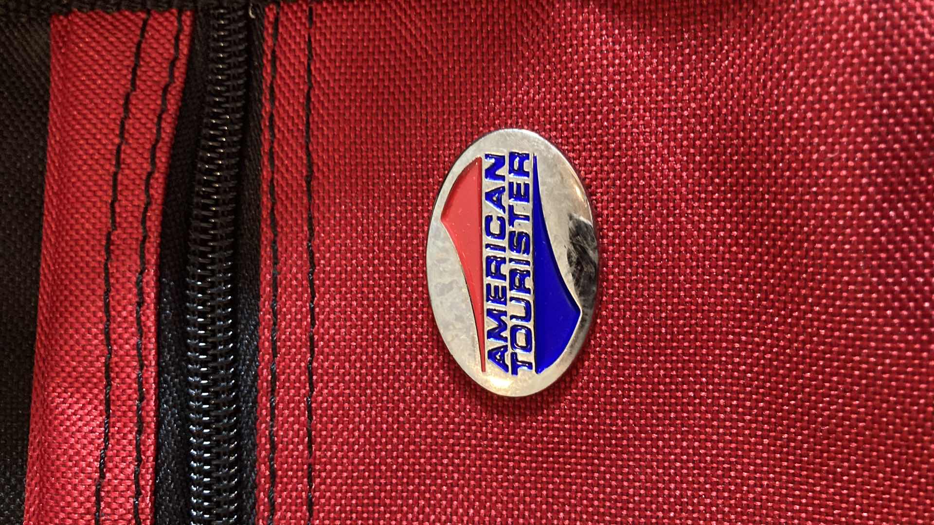 Photo 1 of AMERICAN TOURISTER RED DUFFEL BAG