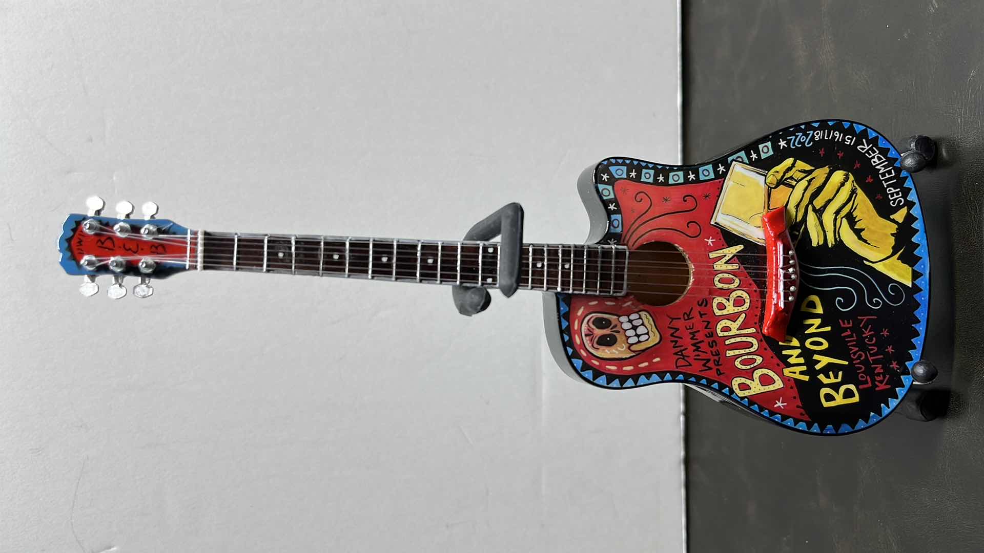 View 1 of RONZ WORLD AXE HEAVEN BOURBON & BEYOND 2022 MINIATURE GUITAR W STAND IN ORIGINAL BOX,  3.75” X 1” H10”