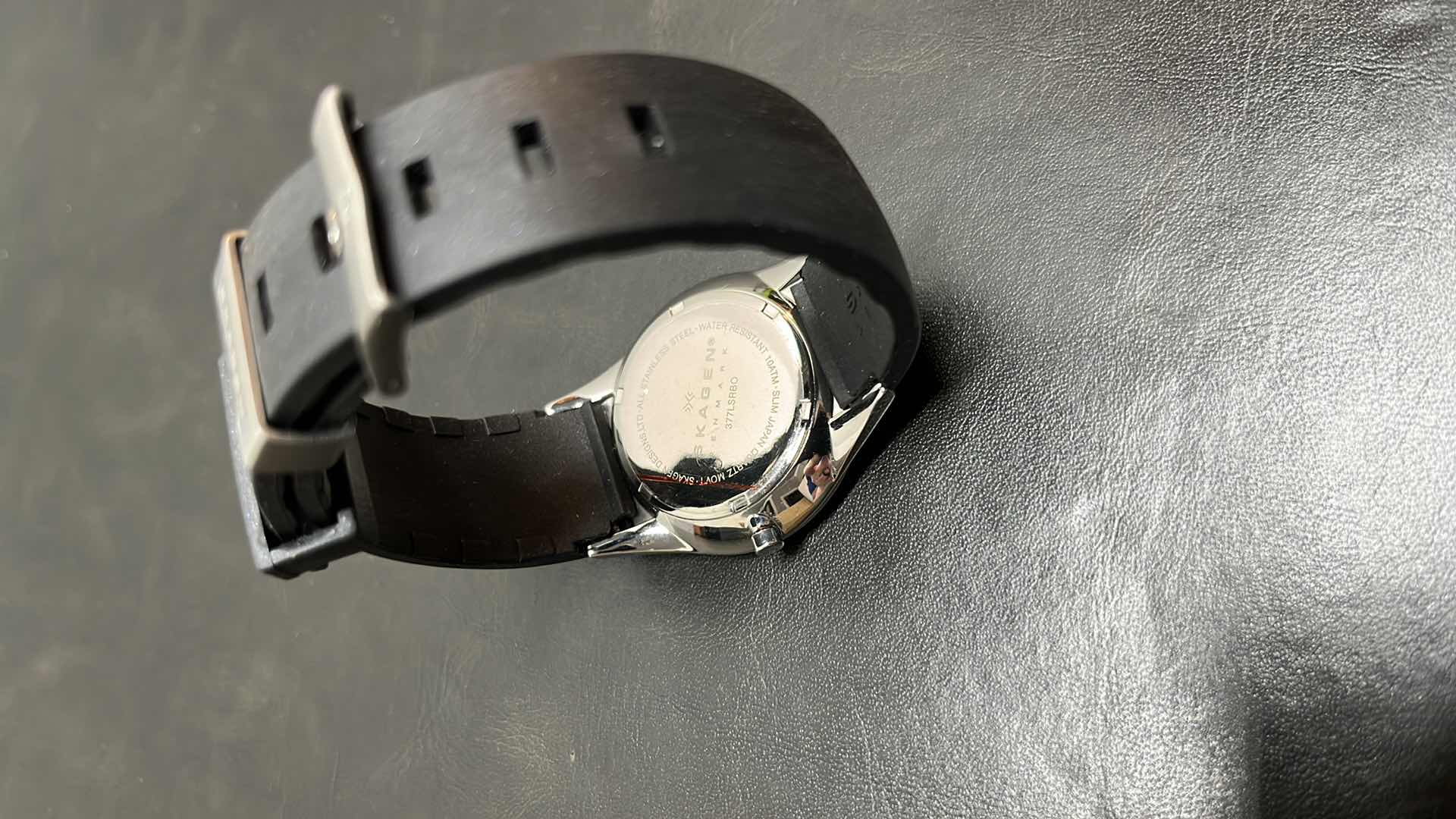 Photo 1 of MENS SKAGEN DENMARK STAINLESS STEEL CASE MULTIFUNCTION WATCH W RUBBER STRAP, BLACK DIAL W ROSE GOLD INDICATORS IN ORIGINAL BOX, MODEL 377LSRBO