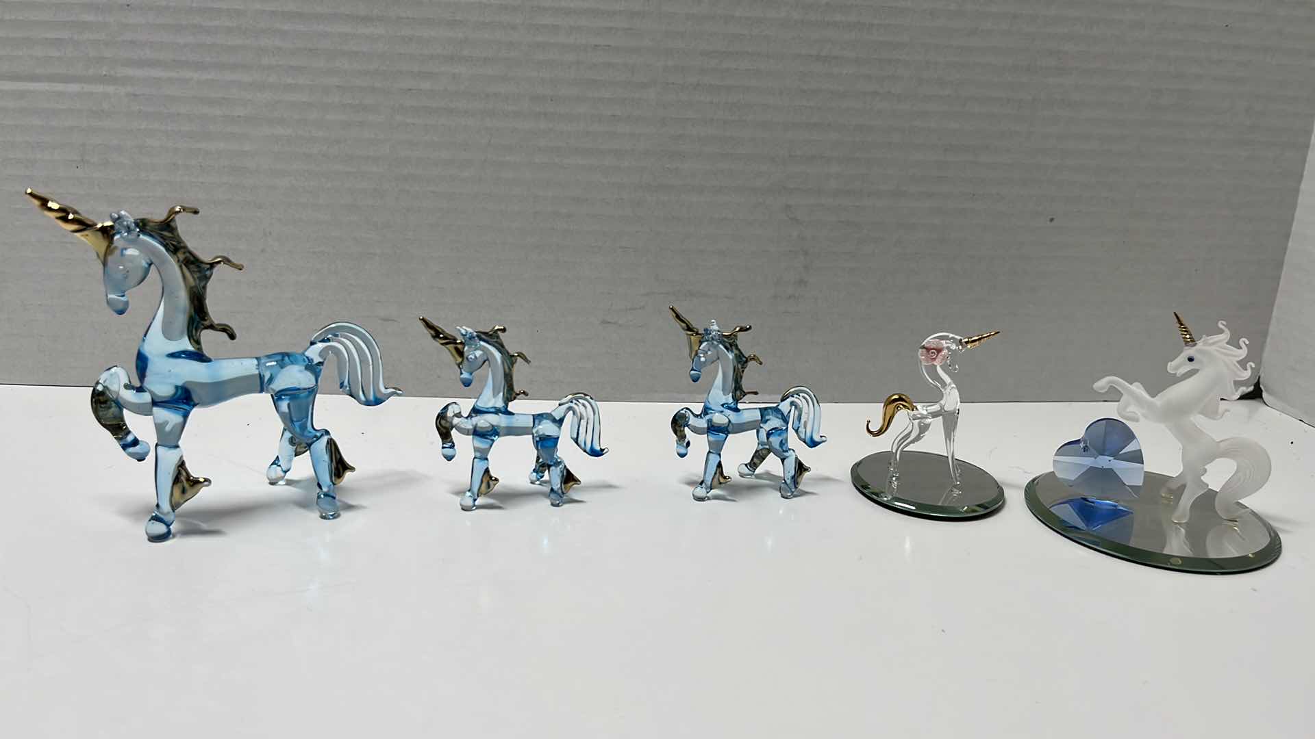 Photo 1 of HAND BLOWN CLEAR BLUE GLASS UNICORNS W GOLD ACCENTS & MIRRORED HAND BLOWN UNICORNS (5)