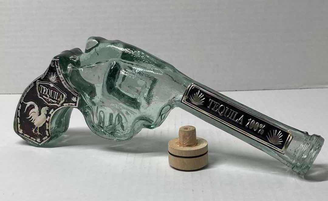 Photo 1 of LOS CABOS GLASS REVOLVER LIQUOR BOTTLE & KAH GLASS SKULL LIQUOR BOTTLE