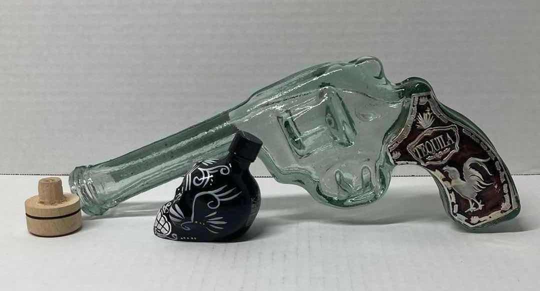 Photo 1 of LOS CABOS GLASS REVOLVER LIQUOR BOTTLE & KAH GLASS SKULL LIQUOR BOTTLE